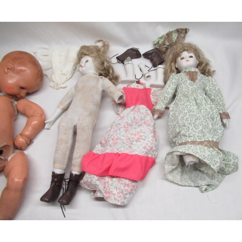 186 - Three various dolls and a collection of dolls clothing