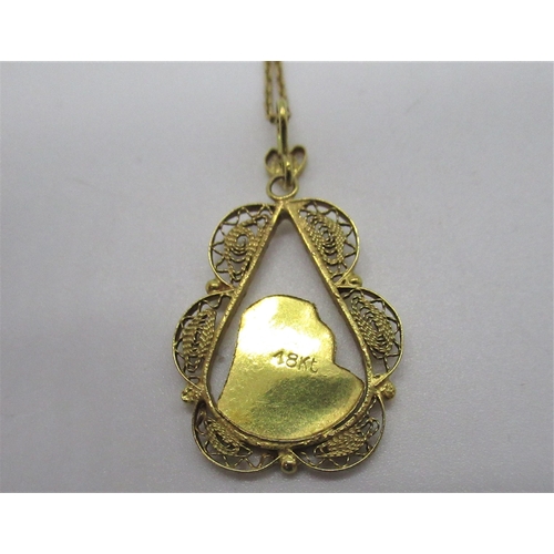 203 - 18ct yellow gold religious pendant in filigree tear drop mount L3cm on a chain with spring ring clas... 