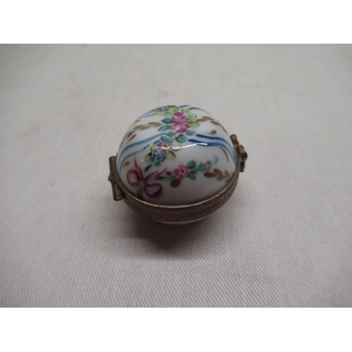142 - Two graduated Limoges France, miniature porcelain boxes with hinged lids and hand painted decoration... 