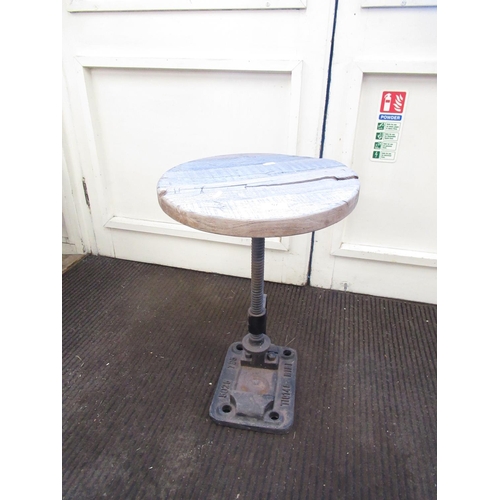 77 - Unusual C20th stool, circular wooden top on cast metal base, constructed from a large clamp