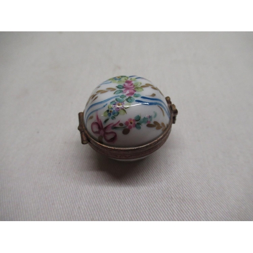 142 - Two graduated Limoges France, miniature porcelain boxes with hinged lids and hand painted decoration... 