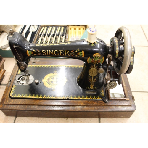 812 - Singer hand sewing machine, black body with gilt detail and decoration, number F640657, in oak case