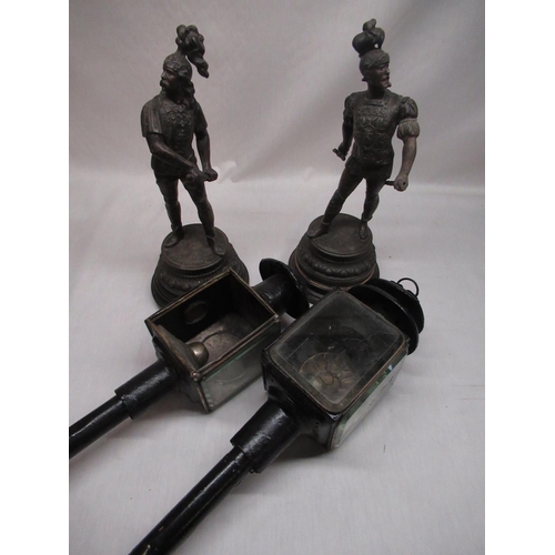 236 - Two late C19th Japanned metal coach lamps and a pair of patinated spelter figures of knights