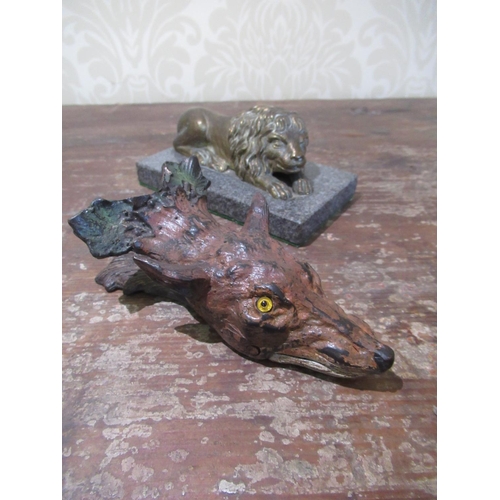 2095 - C20th gilt brass paperweight in the form of a recumbent lion on a polished slate base L13cm, and a p... 