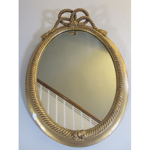 2007 - Regency style gilt wood and gesso wall mirror, oval plate in rope twist surround with tasseled knot ... 