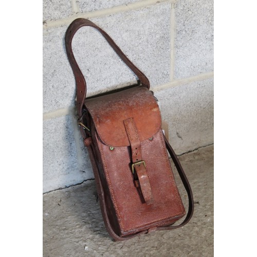 2122 - WWII leather magazine case, interior fitted for four curved magazines, leather buckle and carry stra... 