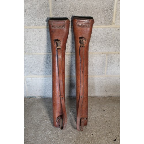 2124 - Two early C20th tan leather gun cases, tapering bodies with cover and brass buckle