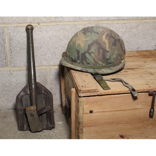 3341 - American M6 helmet with camouflage covering, possibly 1960s, and a entrenching tool with leather and... 