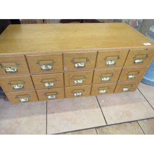59 - Mid C20th light oak index card chest with fifteen drawers and brass hood handles, W84cm D40cm H36cm