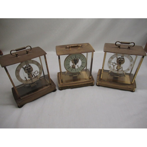 44 - Three Kundo electronic lacquered brass cased mantel clocks