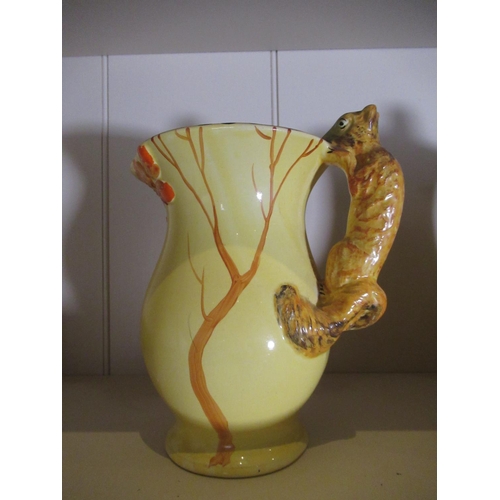 2187 - Clarice Cliff Harvest pattern jug, two Wadeheath jugs with Parrot handles, a similar Burleigh jug an... 