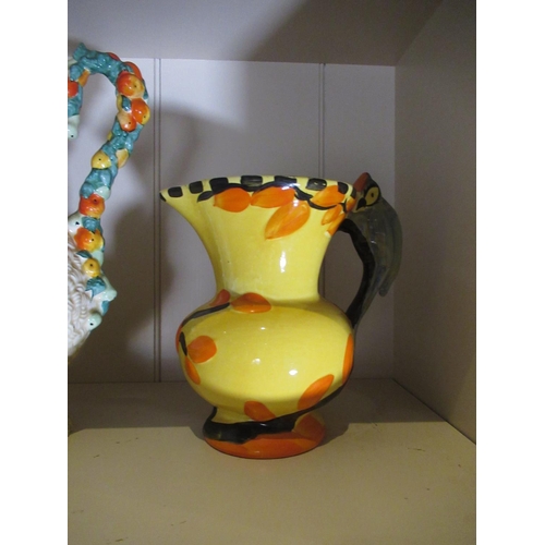2187 - Clarice Cliff Harvest pattern jug, two Wadeheath jugs with Parrot handles, a similar Burleigh jug an... 