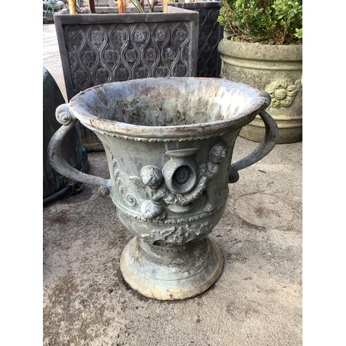 3222 - Pair of lead coated cast iron garden urns, two handled bodies decorated with cherubs on circular tap... 