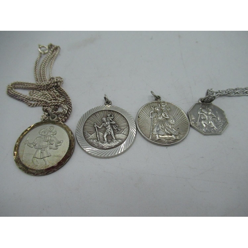 22 - Hallmarked Sterling silver ingot charm L4.5cm,  and four silver St Christopher pendants, two silver ... 