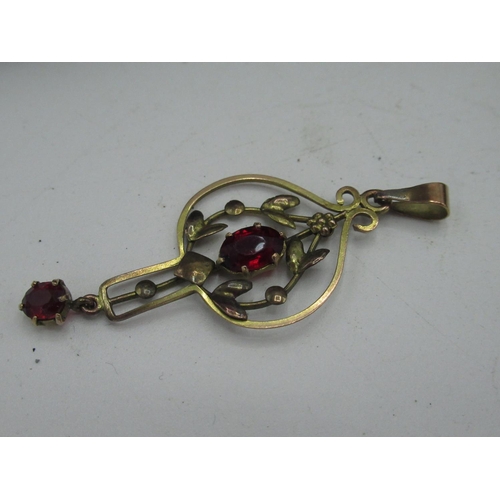 42 - 9ct gold pendant with claw set red stone in pierced foliage key hold mount stamped 9ct, Sterling sil... 