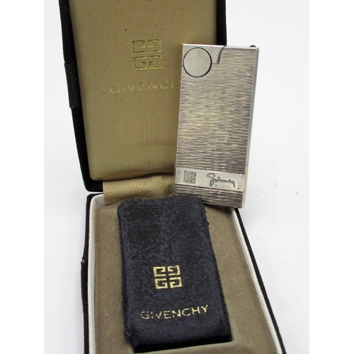 45 - Givenchy lighter in leather pouch and fitted leather case