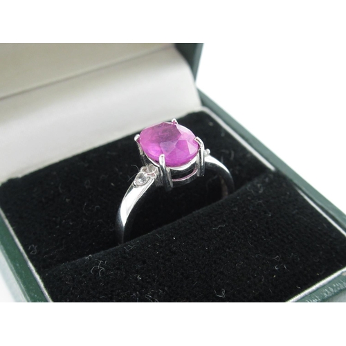 4 - 9ct white gold and pink ruby dress ring, central stone flanked by two small diamonds, size N