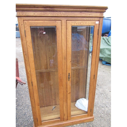 888 - Modern oak display cabinet enclosed by pair of bevelled edged glazed cupboard doors