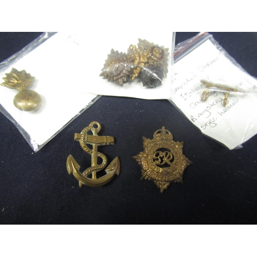 301 - Collection of ten pieces of military insignia including Royal Navy, Torpedo Training Anchor, WWI Geo... 