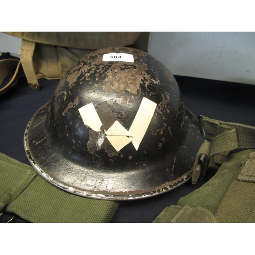 304 - Collection of WWII military uniform including black Brody helmet with full lining and strap, boxed c... 