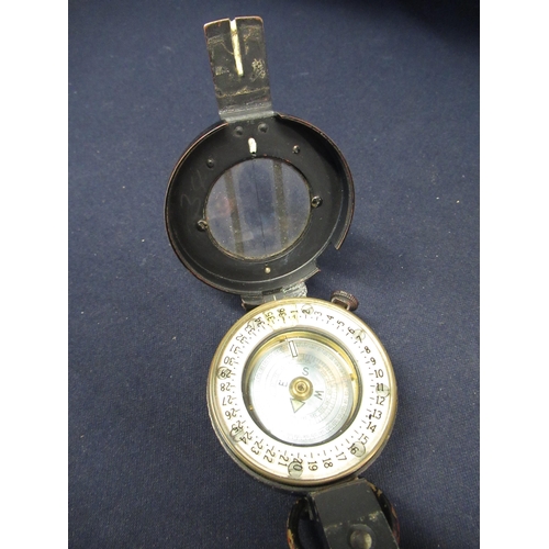 125 - T. G. & Co marching compass with registration no. 218230, with crowsfoot military arrow dated 1943, ... 