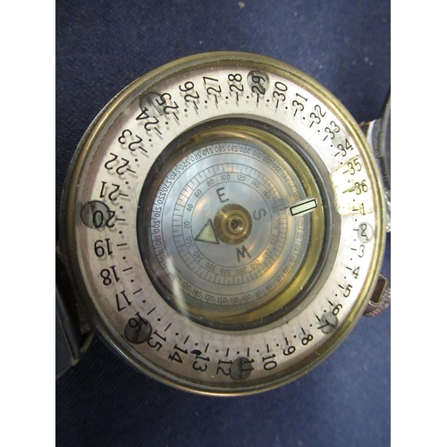 125 - T. G. & Co marching compass with registration no. 218230, with crowsfoot military arrow dated 1943, ... 