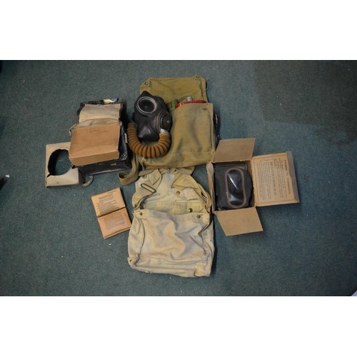 291 - Two boxed WWII gas masks, WWII gas mask bag with contents stamped H & Sons 1941 with crowsfoot arrow... 