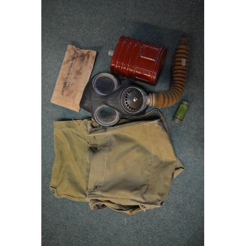 291 - Two boxed WWII gas masks, WWII gas mask bag with contents stamped H & Sons 1941 with crowsfoot arrow... 