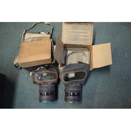 291 - Two boxed WWII gas masks, WWII gas mask bag with contents stamped H & Sons 1941 with crowsfoot arrow... 