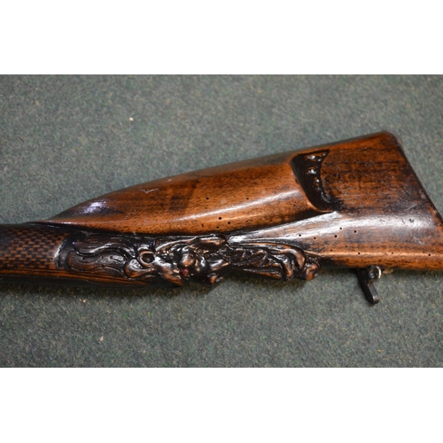 345 - Double barreled muzzle loading pinfire shotgun with ornate carving to butt in the shape of two lion ... 