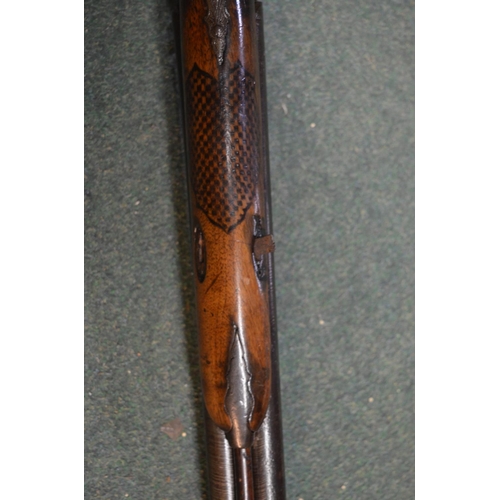 345 - Double barreled muzzle loading pinfire shotgun with ornate carving to butt in the shape of two lion ... 