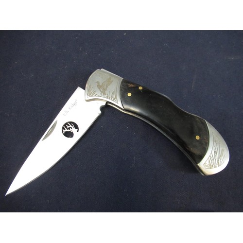 172 - Elk Ridge pocket knife with black two piece handle with decoration and pierced blade