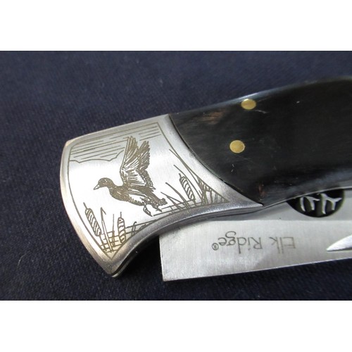 172 - Elk Ridge pocket knife with black two piece handle with decoration and pierced blade