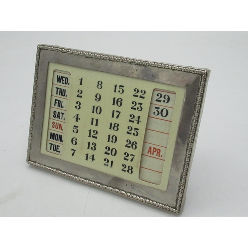 110 - Geo.V ivorine desk calender with hallmarked Sterling silver frame with decorative raised edge by Cha... 