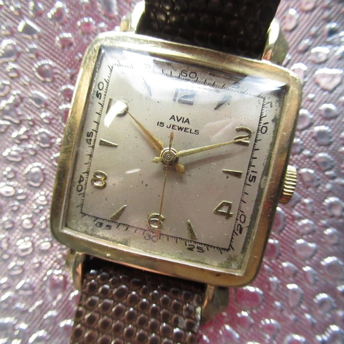 205 - 1950's Avia 9ct gold cased hand wound wristwatch, square gold case with snap on back stamped .375 an... 