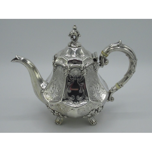 1157 - Victorian hallmarked Sterling silver teapot with octagonal tapered body and leaf scroll finial, on o... 