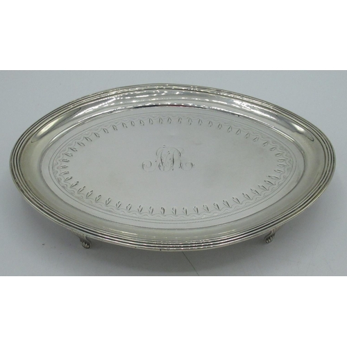 1168 - Geo.III hallmarked Sterling silver oval teapot stand with bright cut and monogramed decoration on sh... 