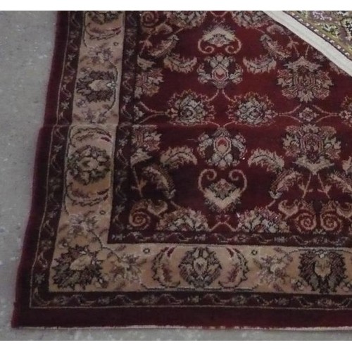 336 - Traditional pattern acrylic rug, brown ground with central floral patterned field W107cm L170cm and ... 