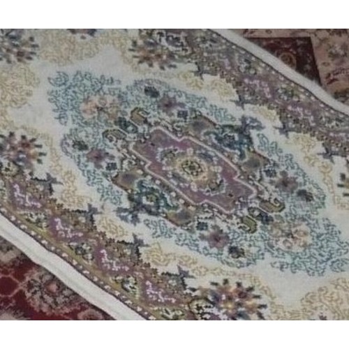 336 - Traditional pattern acrylic rug, brown ground with central floral patterned field W107cm L170cm and ... 