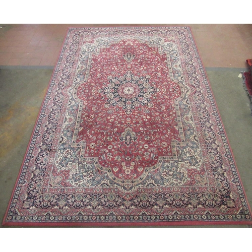 331 - Late C20th Imperial Lano traditional pattern wool rug, brick red ground with central floral medallio... 