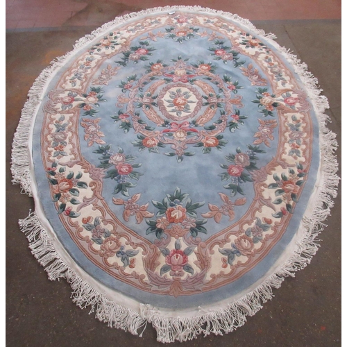 343 - Chinese oval embossed washed woolen rug, central sky blue ground with central rose medallion surroun... 