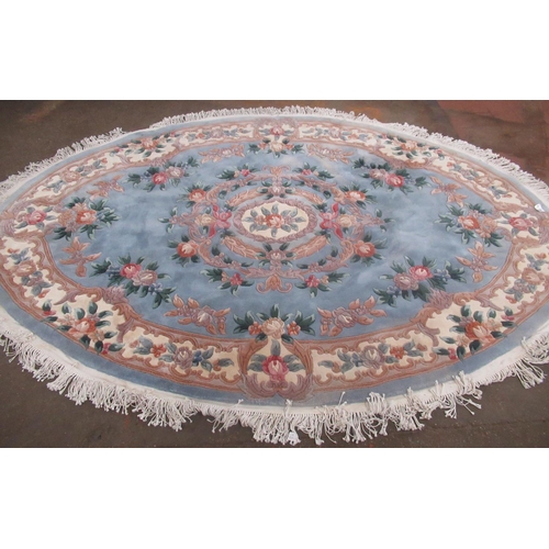 343 - Chinese oval embossed washed woolen rug, central sky blue ground with central rose medallion surroun... 