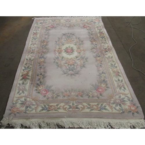 348 - C20th Chinese embossed washed woolen rug, beige ground with central rose motifs surrounded by floral... 