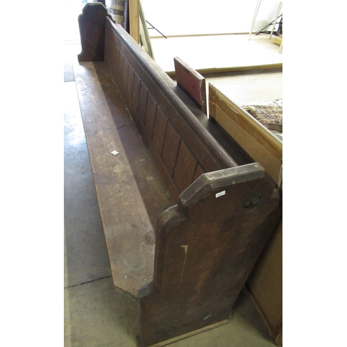 183 - Victorian pine church pew, with panel back and solid seat on shaped end supports, W250cm D46cm H92cm