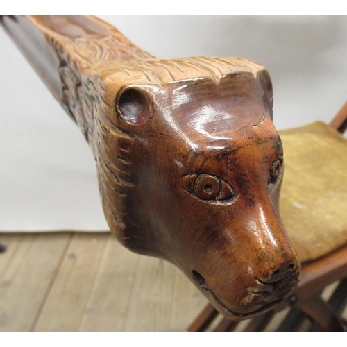 188 - Continental Savonarola type folding chair with serpentine carved back and lions head arms on paw fee... 