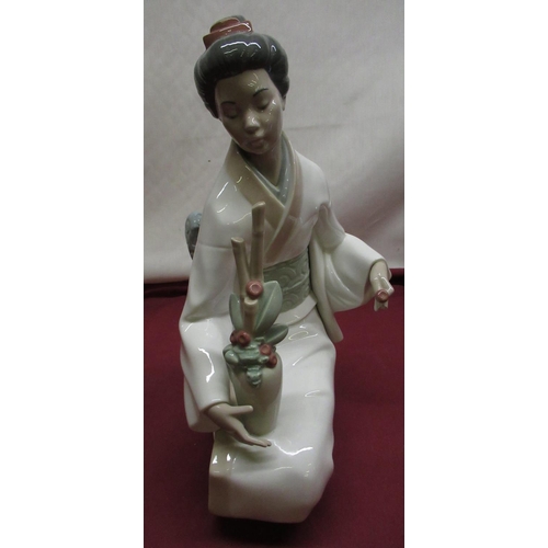 171 - Nao model of seated Geisha arranging flowers, H36cm