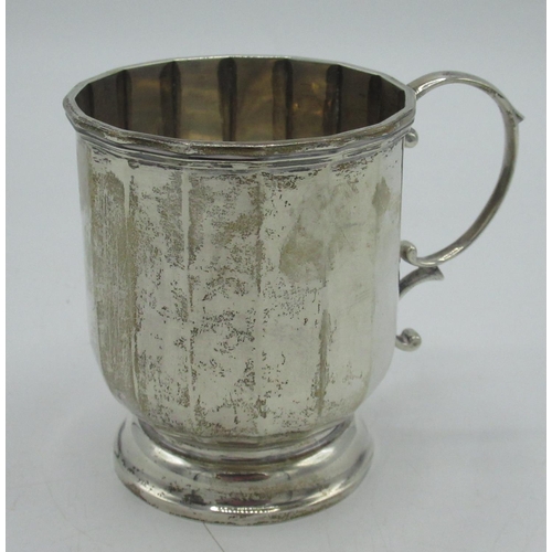 21 - Hallmarked Sterling silver christening mug of paneled design with C scroll handle, Birmingham 1927, ... 