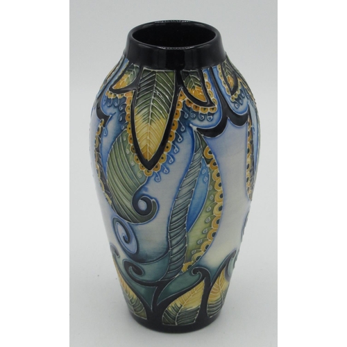 24 - Moorcroft pottery vase c2010 in a blue and yellow colourway with a tube lined design of scrolling le... 