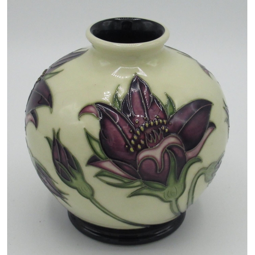 25 - Moorcroft squat vase decorated in a tube lined pattern of a purple flower on cream background, H10.5... 