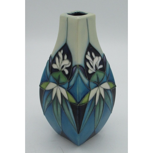 31 - Moorcroft pottery small vase in tube lined white flower pattern of blue green background, H13cm